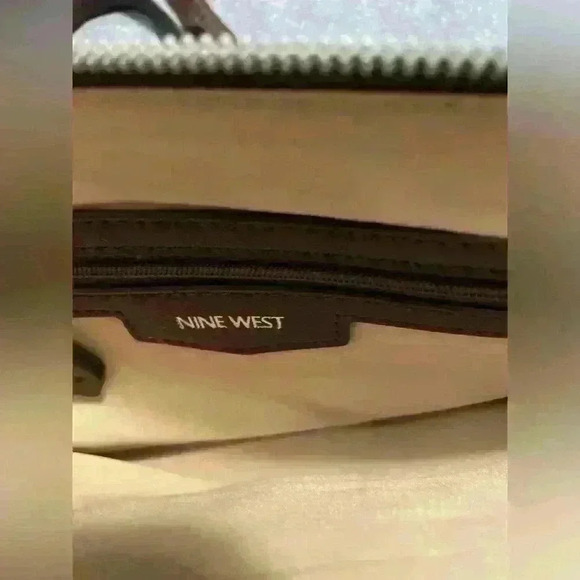 Nine West Crossbody brown with silver hardware. Snap closure and zipper pockets. - Picture 9 of 11